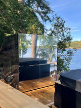 Side View of a Custom Outdoor Wellhouse IceCube sauna wrapped in mirror reflecting a hot tub and majestic Muskoka lakeside scene